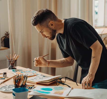 An art teacher checks his students' homework, standing at the school board in class.A drawing...