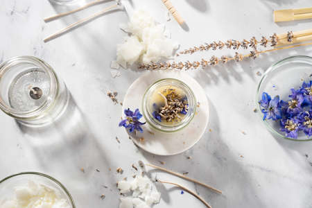 Set tools for homemade natural eco-friendly soy wax candles, wick, perfume, essential oil on a marble table. making process. trendy DIY. Craft hobby, small business, artisan products concept.の写真素材