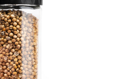 Organic Dried coriander seeds Coriandrum sativum in jar for seasonings and spices on a white background. Ingredient for the preparation of delicious delicacies. Spicy food concept.Top view.Copy spaceの写真素材