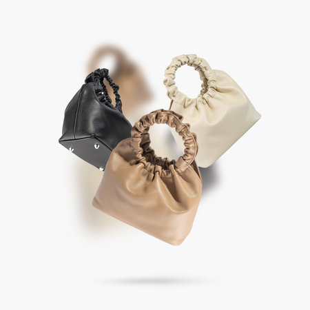 Eco leather handbags different colors and sides floating on a gray background. Women's fashion, clothing concept. Stylish female accessory. Creative Minimalistic layout with bags. Objects for design.の写真素材