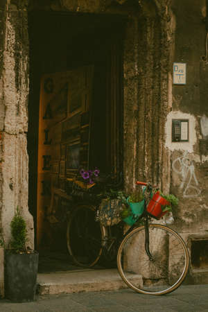 a bicycle with flowers stands on an empty street of the old city. Krakow, Polandの写真素材
