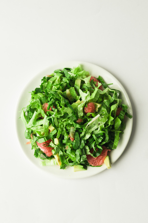 healthy vegan avocado and beet salad in white bowl, top viewの写真素材