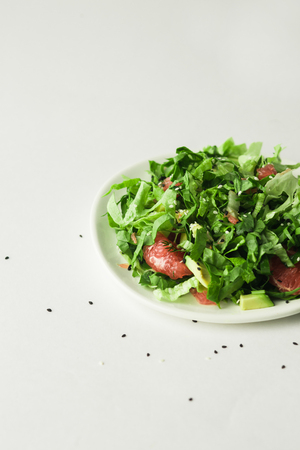 healthy vegan avocado and beet salad in white bowl, green salad with avocado and graipfuitの写真素材