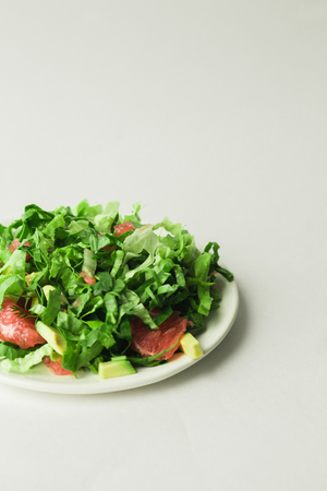 healthy vegan avocado and beet salad in white bowl, green salad with avocado and graipfuitの写真素材