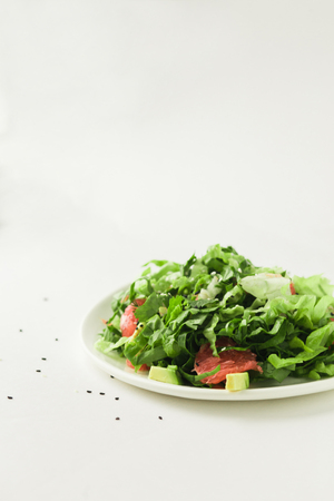 healthy vegan avocado and beet salad in white bowl, green salad with avocado and graipfuitの写真素材