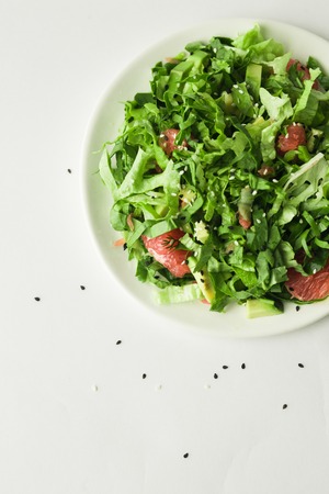 healthy vegan avocado and beet salad in white bowl, green salad with avocado and graipfuitの写真素材