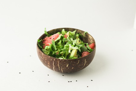 healthy vegan avocado and green salad in coconut bowlの写真素材
