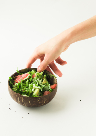 healthy vegan avocado and green salad in coconut bowlの写真素材