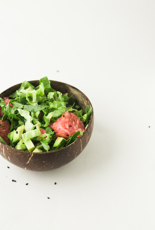 healthy vegan avocado and green salad in coconut bowlの写真素材
