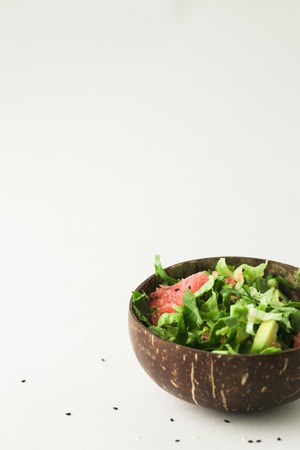 healthy vegan avocado and green salad in coconut bowlの写真素材