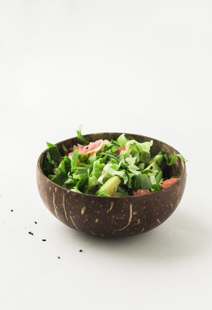 healthy vegan avocado and green salad in coconut bowlの写真素材