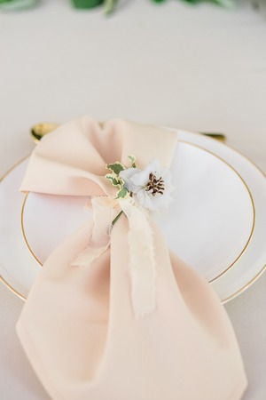 wedding table decorated by plates, knives and forks, candle, moss, flowers roseの写真素材