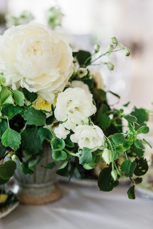 wedding table decorated by plates, knives and forks, candle, moss, flowers roseの写真素材