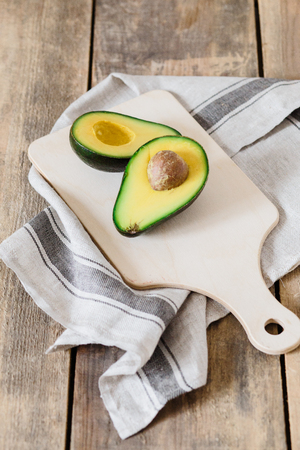 Whole and cut in half of avocado isolated on white background. Simple and delicious tasty recipes for everything from breakfast to dessert. Every meal of the day. For diet helps improve your overall.の写真素材