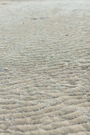and surface on the beach, wavy sand on the oceanの写真素材