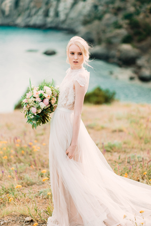 Stunning bride in beautiful wedding dress on natural background.の写真素材