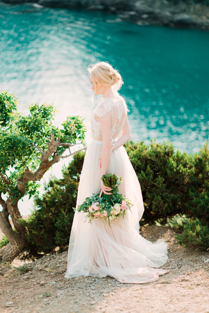 Stunning bride in beautiful wedding dress on natural background.の写真素材