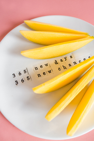 Mango fruit and mango slices on the white plate. Tropical fruit concept. plate motivation