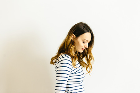 Portrait girl in a striped t-shirton a white backgroundの写真素材