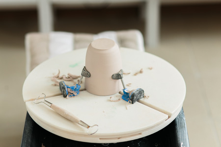 ceramic mug made on a Potter's wheel in the studio. Workshop on modeling on the potter's wheel.