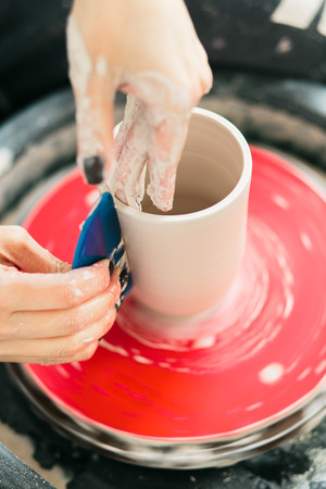 ceramic mug made on a Potter's wheel in the studio. Workshop on modeling on the potter's wheel.の写真素材