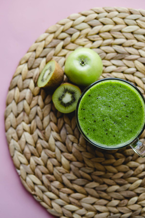 Healthy green cocktail in a glass Cup with spinach, kiwi and green Appleの写真素材