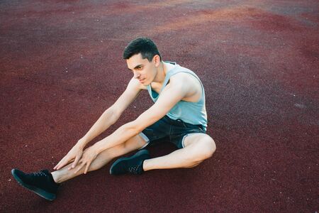 Young man doing outdoor exercise in new York. he is wearing a grey top and light sport leggingsの写真素材