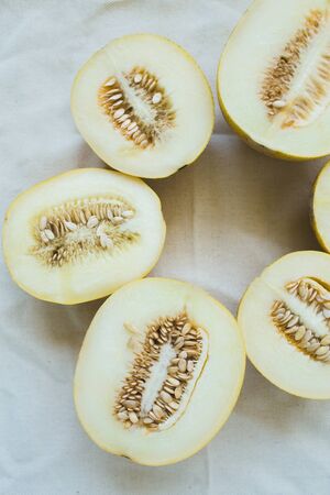 A group of brightly lit melon halves. seasonal summer fruitsの写真素材