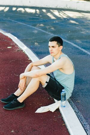 Young man doing outdoor exercise in new York. he is wearing a blue top and sport shortsの写真素材
