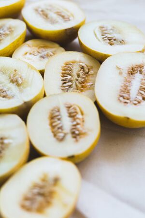 A group of brightly lit melon halves. seasonal summer fruitsの写真素材