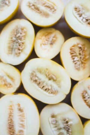 A group of brightly lit melon halves. seasonal summer fruitsの写真素材