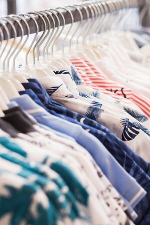 The clothes hanger is Filled with colorful Fabric shirtsの写真素材