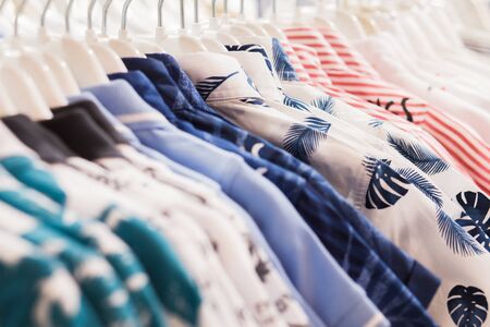 The clothes hanger is Filled with colorful Fabric shirts .Clean shirts hanging on rack in laundry, closeupの写真素材