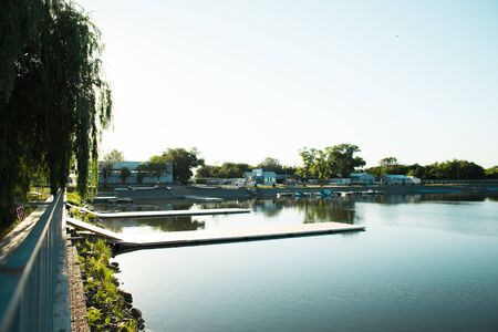 beautiful morning on the lake. The boat next to a pontoon on the water. Summer timeの写真素材