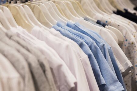 The clothes hanger is Filled with colorful Fabric shirts .Clean shirts hanging on rack in laundry, closeupの写真素材