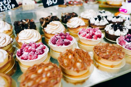 a lot of beautiful delicious cakes with nuts and berries at the street fair. street foodの写真素材