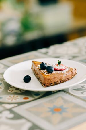 delicious slice of chocolate cake with berries on a white plate