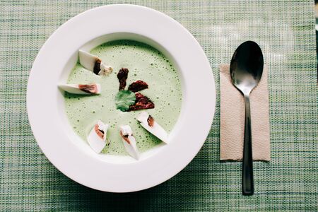 Tom Yam raw food soup with fresh mushrooms on a white plate in a health food restaurant. veganの写真素材