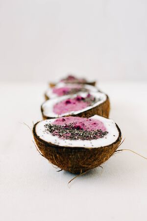 four plates of natural coconut shell with a healthy Breakfast green buckwheat smoothie with berriesの写真素材