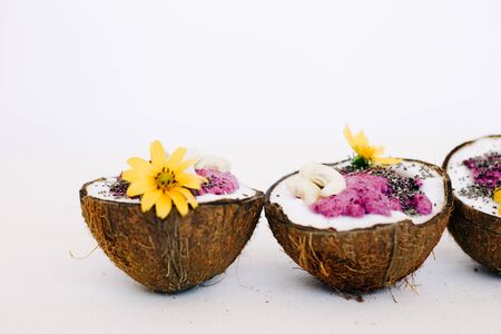 healthy Breakfast berry smoothie with Chia seeds and cashew nuts in a natural coconut plate