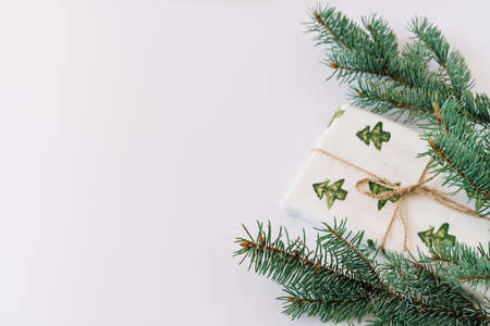 Christmas or new year's background, plain composition of Christmas gifts and fir branches, Flatlay, empty space for greeting text.の写真素材