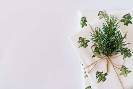 Christmas or new year's background, plain composition of Christmas gifts and fir branches, Flatlay, empty space for greeting text.の写真素材