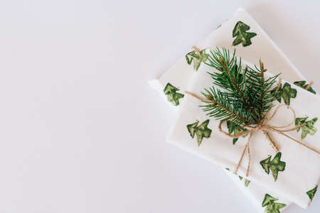 Christmas or new year's background, plain composition of Christmas gifts and fir branches, Flatlay, empty space for greeting text.の写真素材