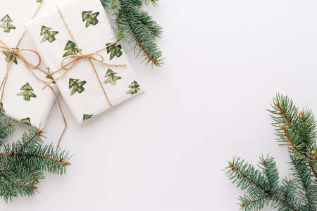 Christmas or new years background, plain composition of Christmas gifts and fir branches, Flatlay, empty space for greeting text.christmas conceptの写真素材