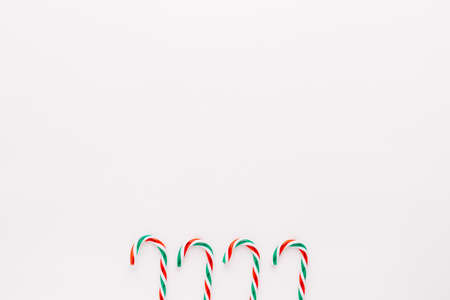 Traditional christmas sweets, candy cane sweets on white background, simple pattern, layout, on white background, top view.minimal conceptの写真素材