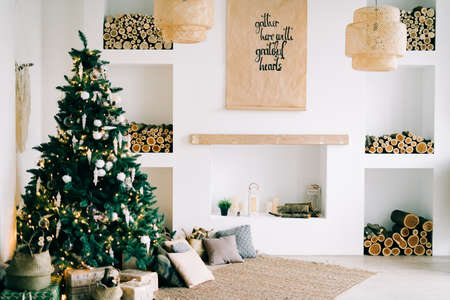 Merry Christmas and happy holidays.Beautiful living room in bright colors, decorated for Christmas in the Scandinavian style.Christmas conceptの写真素材