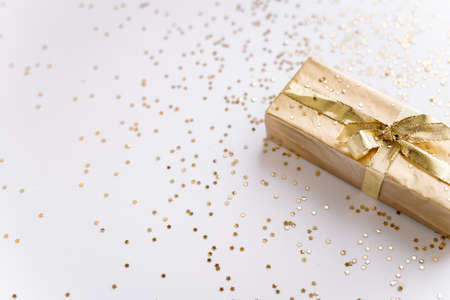 white Christmas or new year's background, plain composition of golden Christmas gifts with golden stars. Flatlay, empty space for greeting text.christmas conceptの写真素材