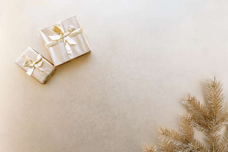 Golden Christmas or new years background,plain composition of golden Christmas gifts and golden fir branches,Flatlay,empty space for greeting text.christmas concept.の写真素材