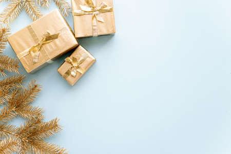 Blue Christmas or new years background,plain composition of golden Christmas gifts and golden fir branches, Flatlay,empty space for greeting text.christmas concept.の写真素材
