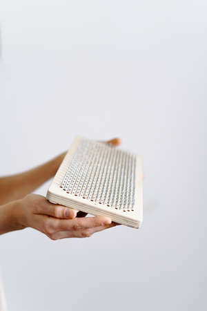 a woman of European appearance holds a wooden board with galvanized nails and puts her hand on top of the nails of the sadhu board. the trend of self-development. the concept of yogaの写真素材